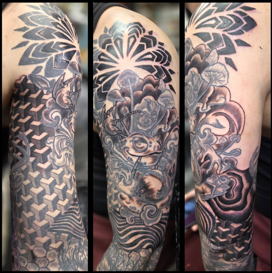 Black and grey full sleeve combining geometric patterns, mushrooms and creature imagery