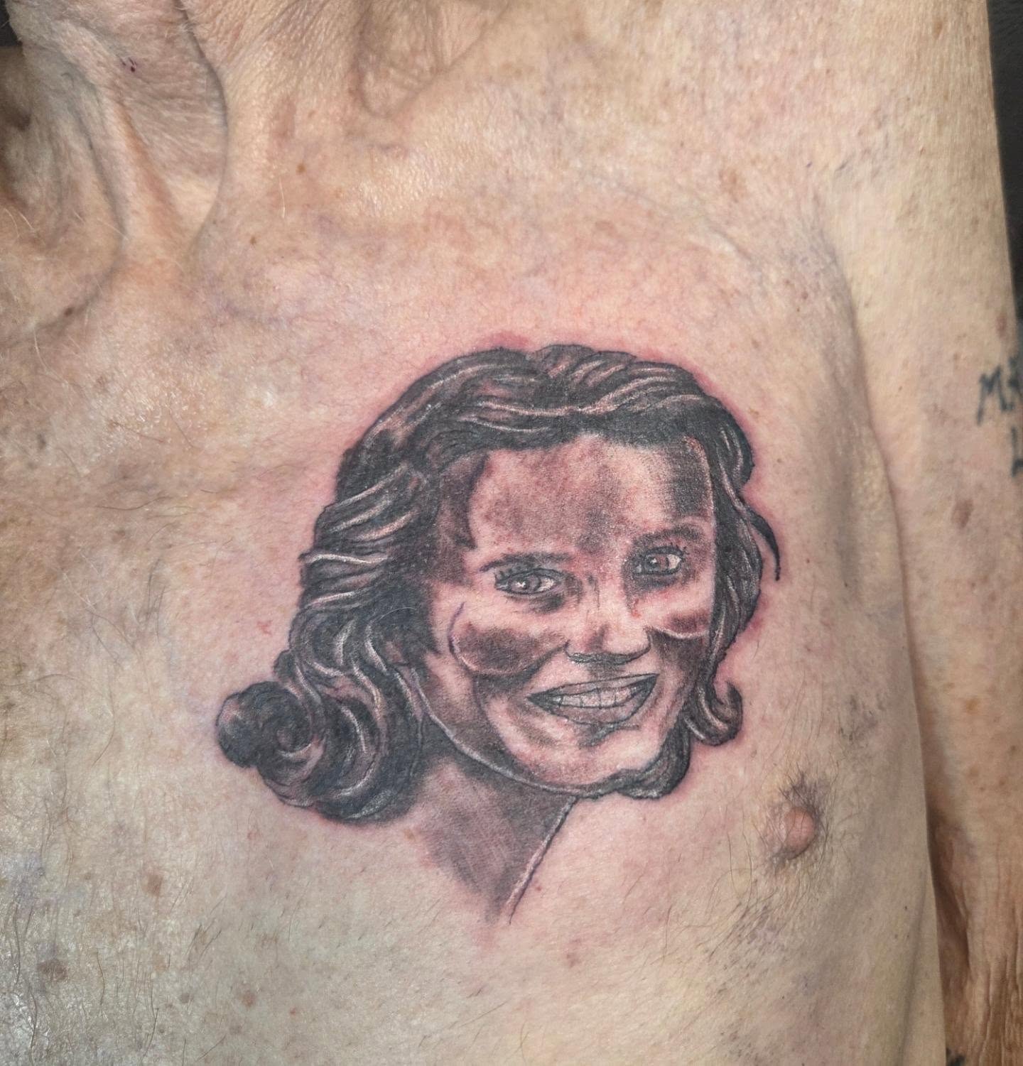 Black and grey memorial portrait tattoo on the chest