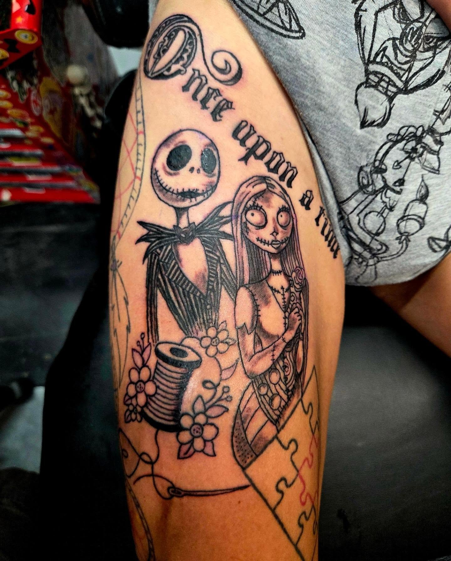 Nightmare Before Christmas character tattoo with Jack and Sally on a leg