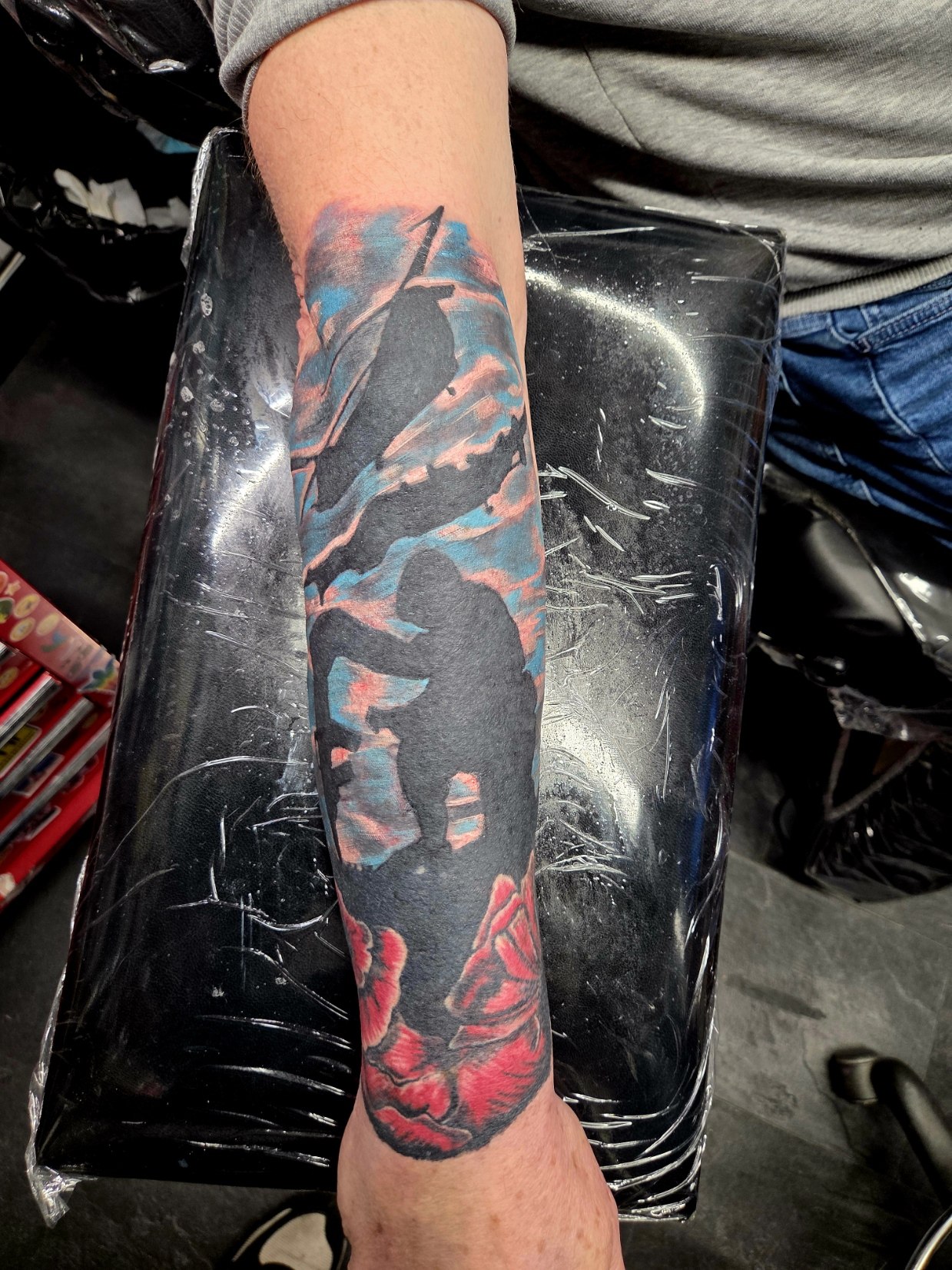 Abstract black and red geometric forearm tattoo