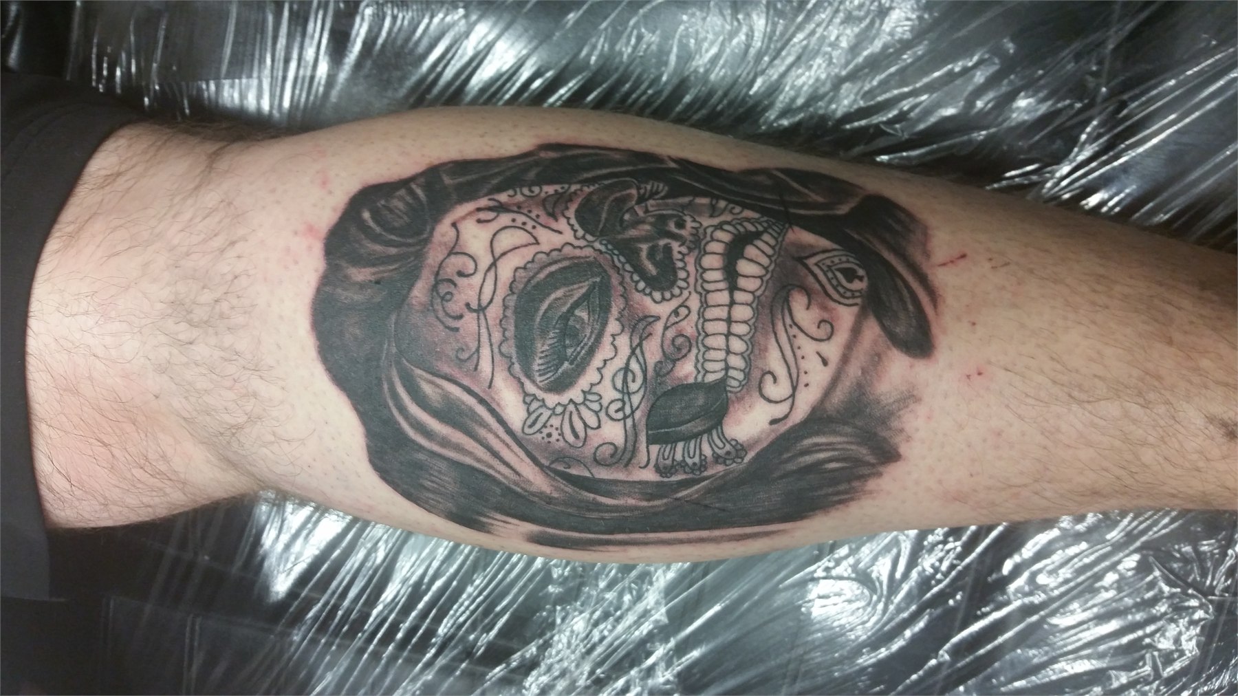 Detailed black and grey sugar skull portrait tattoo